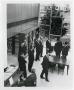 Photograph: [Photograph of a Group of Men Touring the Library]