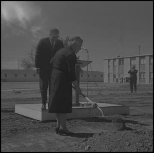 [Photograph of Woman Shoveling Dirt at the Groundbreaking Ceremony for the Jay-Rollins Library]