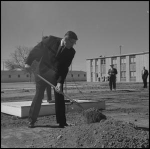 [Photograph of Man Shoveling Dirt at Groundbreaking for Jay-Rollins Library]