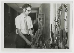 [Photograph of Dr. Ben Pilcher with Cacti]