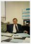 Photograph: [Photograph of Russell Watjen Seated at Desk]