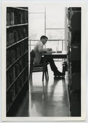 [Photograph of Student Studying at the Library]