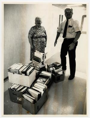 Primary view of object titled '[Photograph of Terry Northup and Ann Cook With Boxes]'.