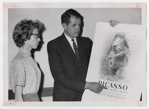 [Photograph of Man and Woman Looking at Picasso Poster]