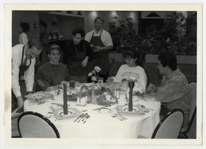 [Photograph of People Around Dinner Table]