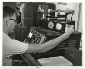 [Photograph of McMurry Student Working on Machine in Science Lab]
