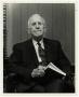 Photograph: [Photograph of Dr. O. P. Clark Seated with Book]