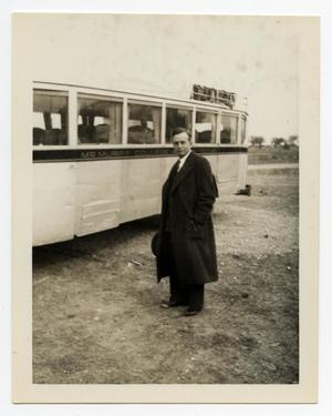 [Photograph of Dr. Clustor Q. Smith by a Bus]