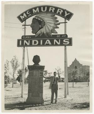 [Photograph of Man Standing Beneath McMurry Indians Sign]