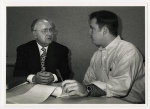 [Photograph of Two Men Sitting at Table]