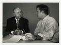 Photograph: [Photograph of Two Men Sitting at Table]
