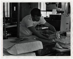 [Photograph of Man Cleaning Kitchen]