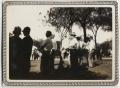 Photograph: [Crowd of people standing under trees]