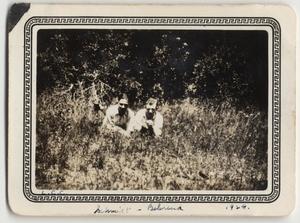 [Two Lutheran Concordia College students, Theodore Schmidt and Alfred Behrendt, lying on ground]