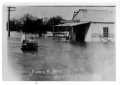 Primary view of [Photograph of Man Driving in Flood Waters]