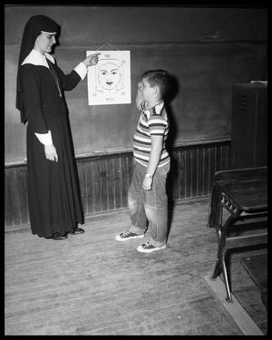 Nun Teaching Boy