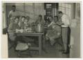 Photograph: [Photograph of Firefighters Sitting at Table]