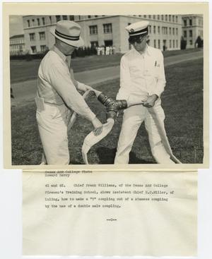 Primary view of object titled '[Photograph of Two Men With Hose]'.