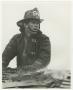 Photograph: [Firefighter on a Smoking Roof]
