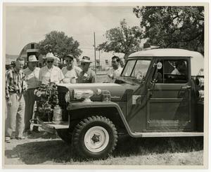 [Group of Men Looking at Jeep]