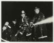 Photograph: [Three Firefighters Holding Hose]