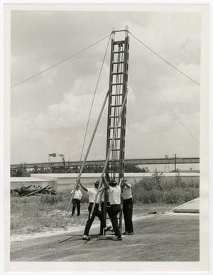 [Photograph of Firemen with Ladder]