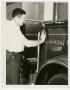 Photograph: [Man Polishing Fire Truck]