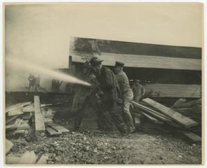 Primary view of object titled '[Firefighters Spraying Water at Fire]'.