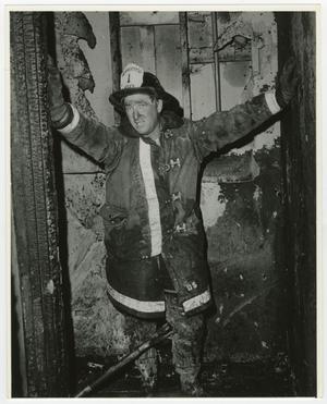 Primary view of object titled '[Firefighter Standing in Charred Building]'.