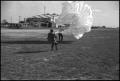 Thumbnail image of item number 1 in: '[Photograph of Man with Parachute]'.