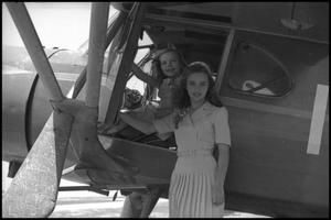 [Photograph of Girls on Airplane]