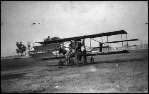 Primary view of object titled '[Photograph of Men and Biplane]'.
