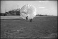 Photograph: [Photograph of Man with Parachute]