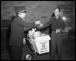Salvation Army Member Giving to a Man