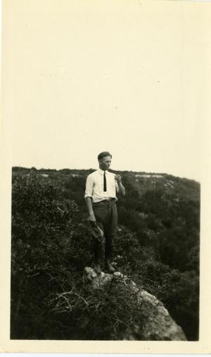 Primary view of object titled '[Photograph of Ernest Witt on a Rock]'.