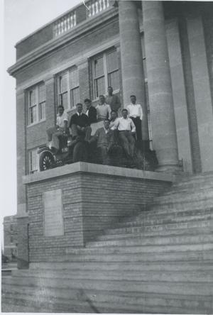 [Photograph of Administration Building with Men and Car]