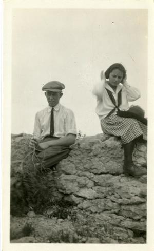 Primary view of object titled '[Photograph of Ernest Witt and Young Woman on Wall]'.