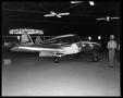 Photograph: [People Near Planes in a Hanger]