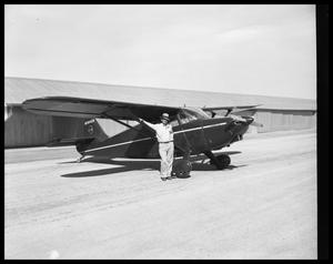 Primary view of object titled '[Man Posing with an Airplane]'.