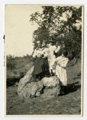 [Four Girls Standing on a Rock]