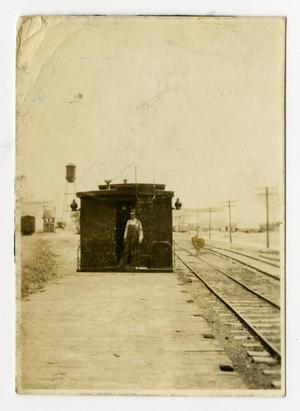 [Trainman with Boxcar beside Railroad Tracks]