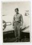 Photograph: [Photograph of Sgt. Smith and Airplane]