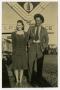 Photograph: [Photograph of Couple and Coca Cola Sign]