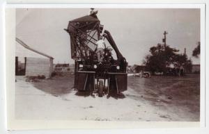 Primary view of object titled '[N. C. and Tommy Berndt Working on Cotton Picker]'.