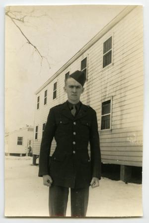 [Photograph of Soldier Outside Barracks]