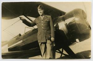 [Photograph of Soldier and Biplane]