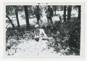 [Photograph of Sergeant Stan Folkman Digging Hole]