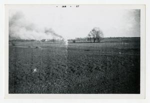 [Photograph of Field with Smoke in the Distance]