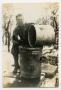 Photograph: [Photograph of Soldier Cleaning Pot]