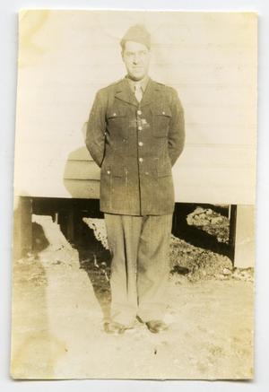 Primary view of object titled '[Photograph of Soldier Outside Barracks]'.